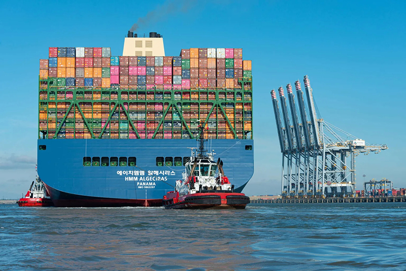 huge ship with containers towering high